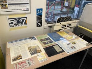 Display of Merseyrail ephemera including booklets, pocket timetables and old maps