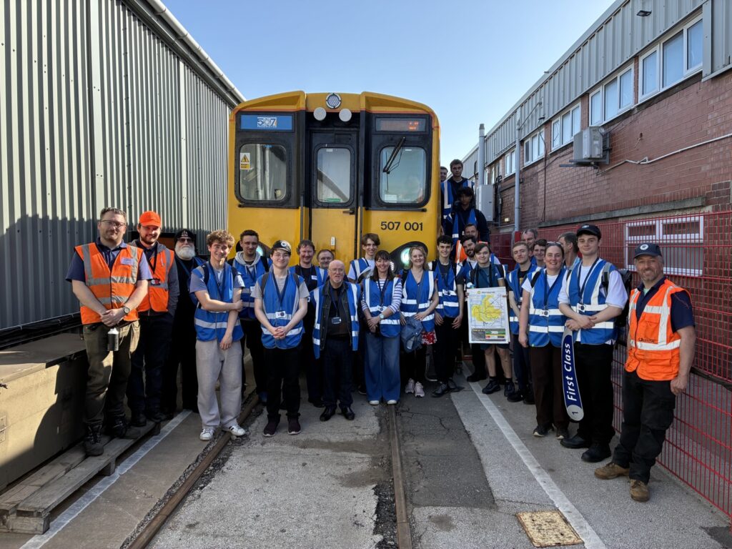 Class 507 Preservation Society members pose in front of 507001 at Litchurch Lane